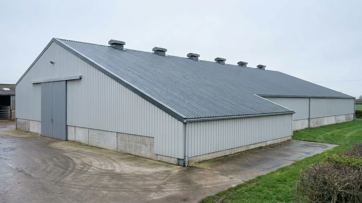 Completed asbestos roof encapsulation in anthracite grey on a grain store near Taunton