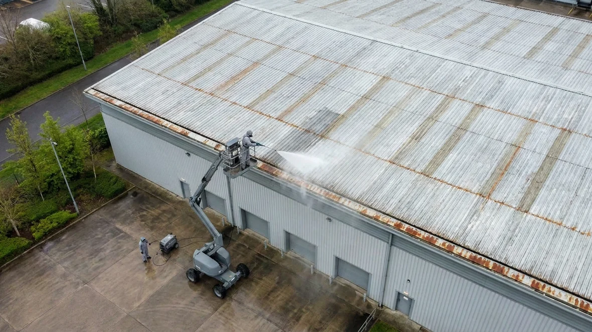 Pressure washing during warehouse roof coating on a distribution warehouse near Huddersfield
