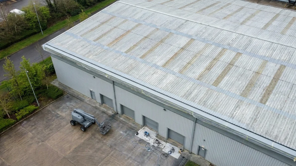 Spot primed repairs during cut edge corrosion treatment on a warehouse near Huddersfield