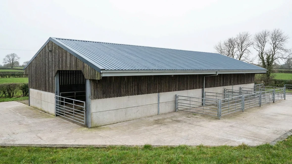 Completed slate blue roof coating on a livestock building near York