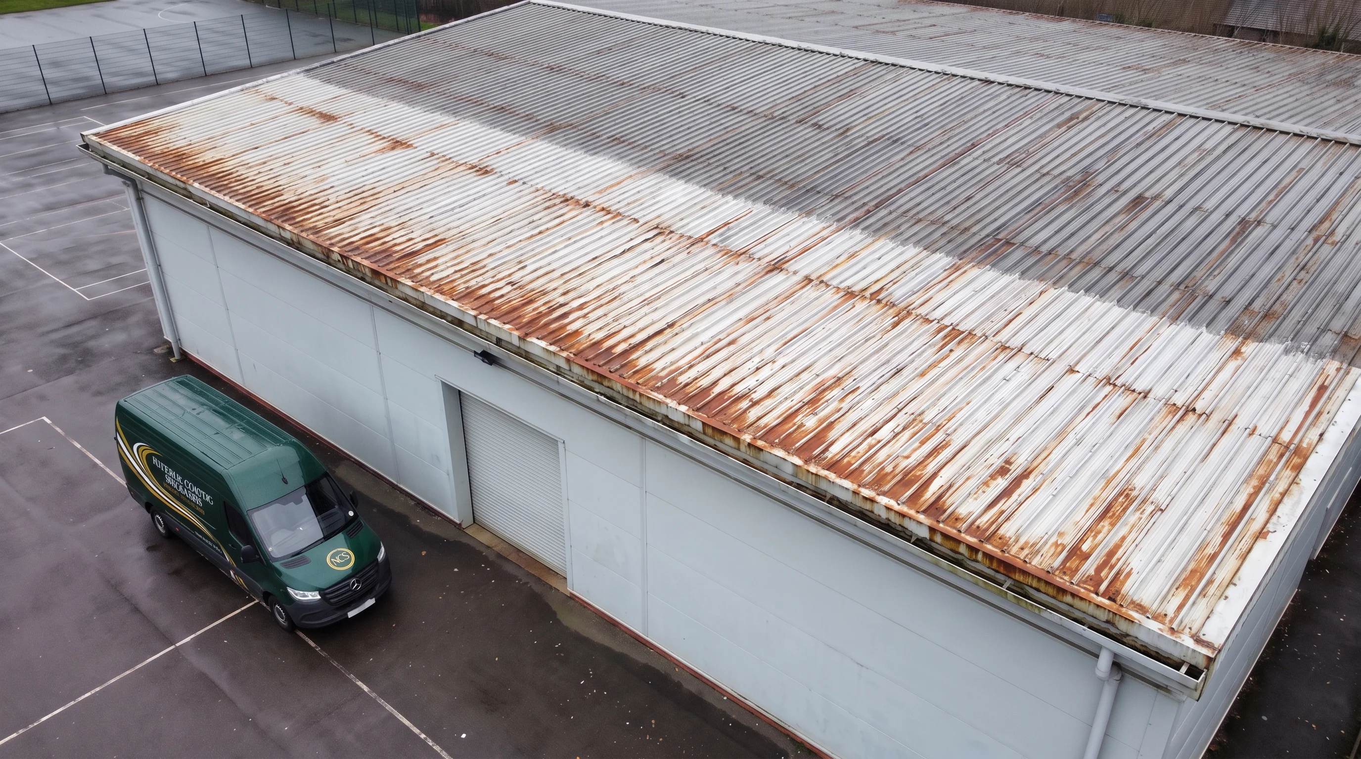 Pressure washing school sports hall roof near Reading