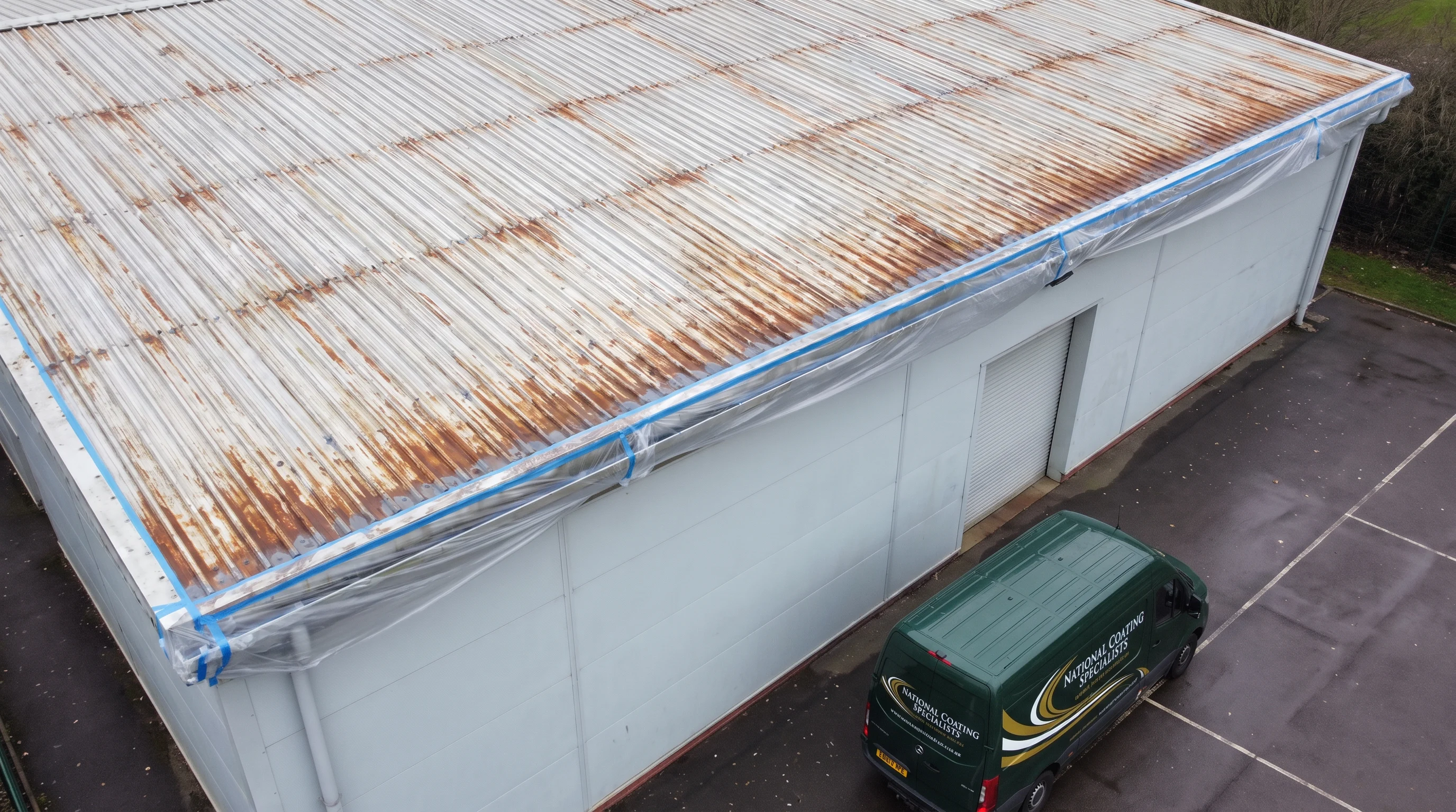 Masked gutter line and primed fixings on school roof near Reading