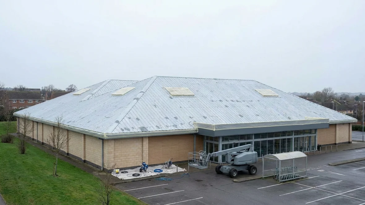 Masked rooflights before coating on a supermarket roof near Exeter