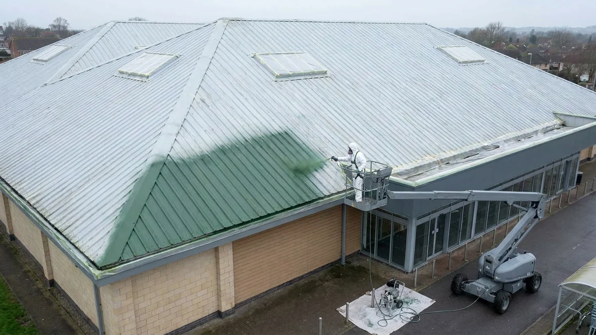 Spraying moorland green coating on a supermarket roof near Exeter