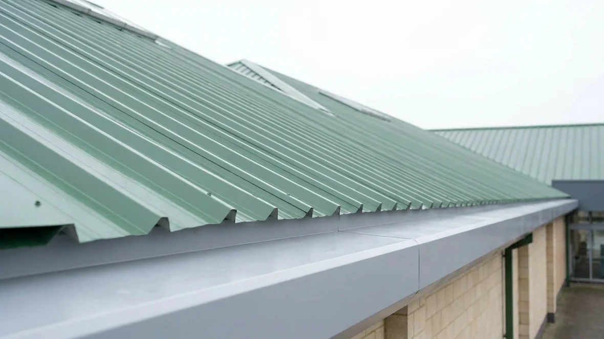 Coated roof edge detail at the box gutter on a supermarket near Exeter