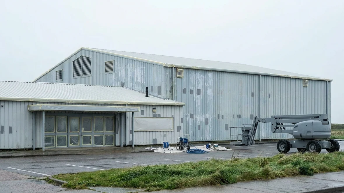 Masked entrance and louvres before wall coating on a leisure centre near Blackpool