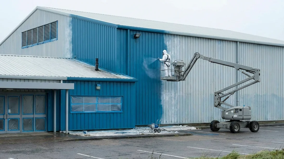 Spraying ocean blue coating on a leisure centre near Blackpool