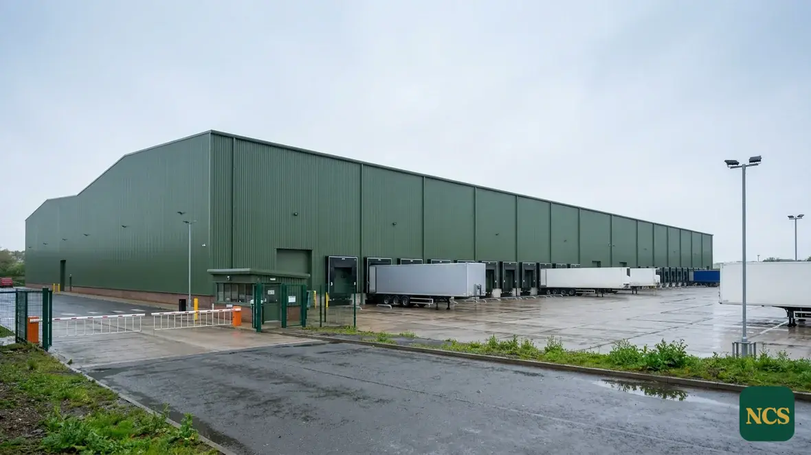 Warehouse cladding spray-coated in moorland green
