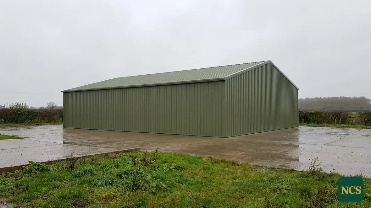 Steel-framed agricultural building coated in olive green RAL 6003