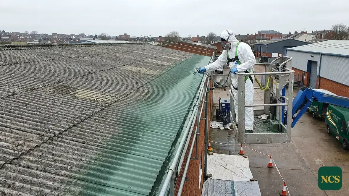 Operative in full PPE encapsulating an asbestos cement roof