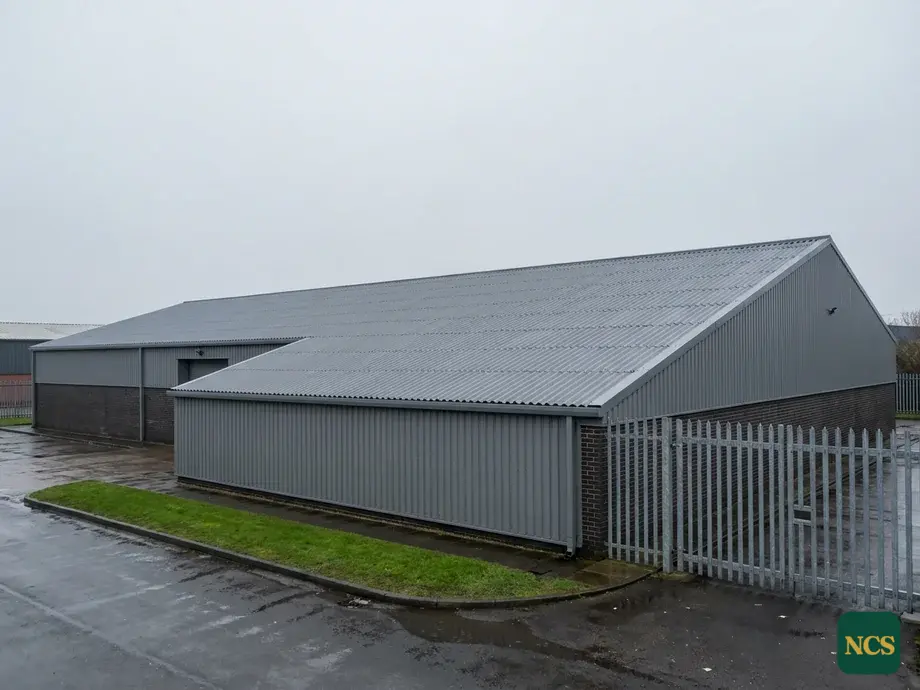 Asbestos-cement roof being encapsulated with a protective coating