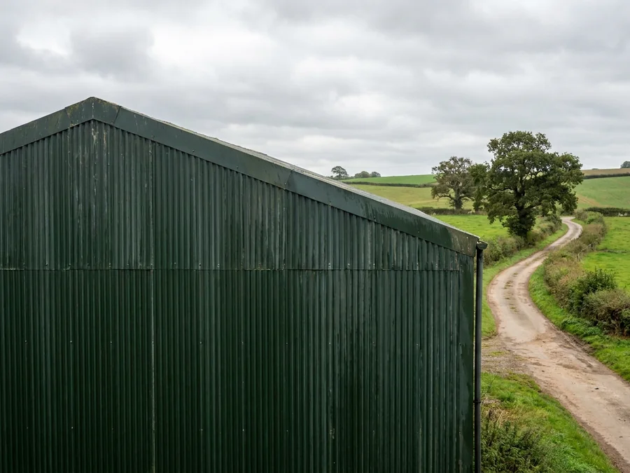 The process of spray applying a durable finish to agricultural metal cladding.
