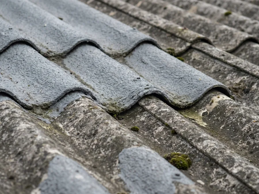 Application of the final topcoat to an encapsulated warehouse roof, showing the new weatherproof finish.