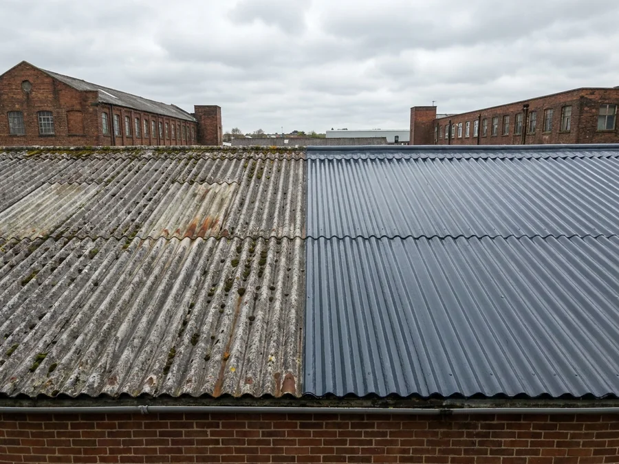 A completed agricultural building roof after asbestos encapsulation, with all work carried out from access platforms.