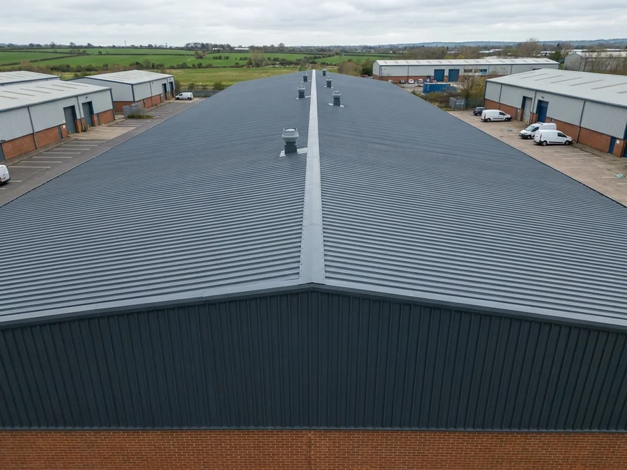 A refurbished metal roof on a large-scale warehouse unit.