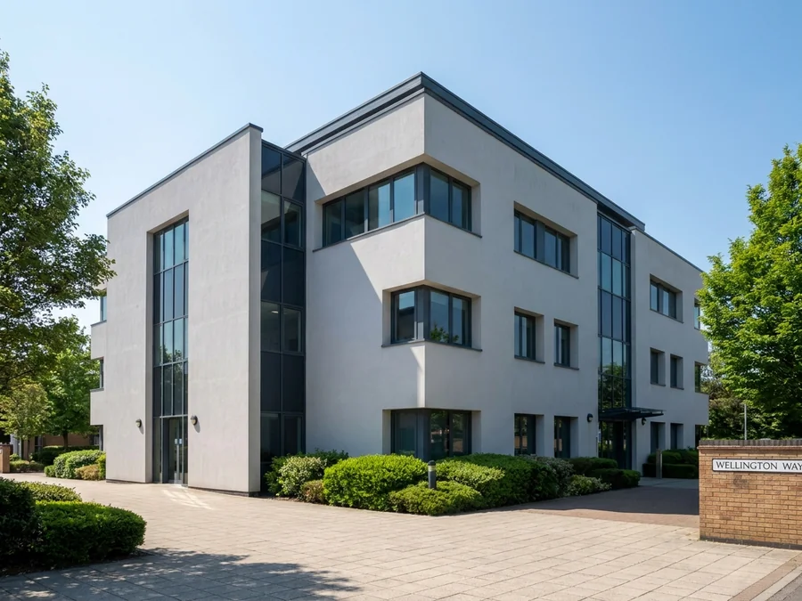 Detailed repair work being carried out on a rendered office building before coating.