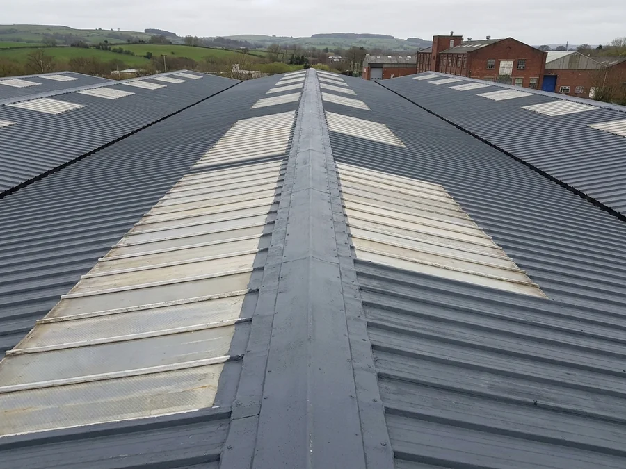 Asbestos cement roof encapsulated to safely seal the surface.