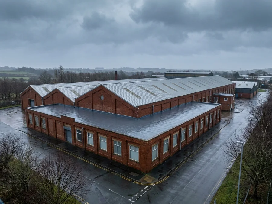 Cut edge corrosion treatment completed on a factory's metal roof sheets.