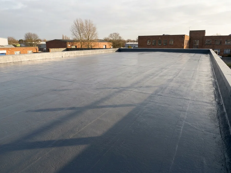 A clean and newly coated metal profile roof on an industrial unit.
