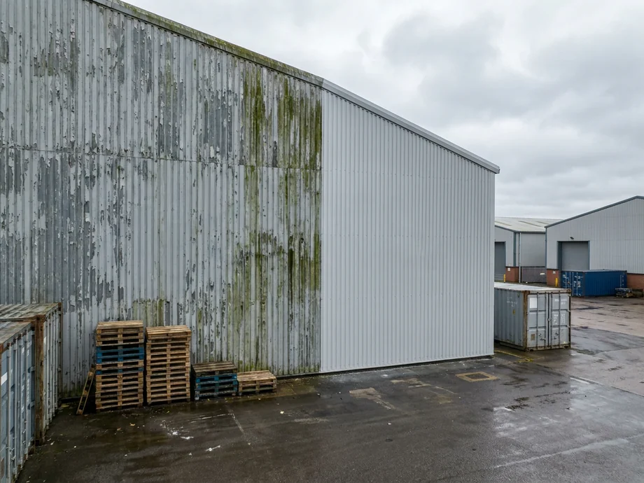 Applying a protective masonry coating to a multi-unit industrial estate.